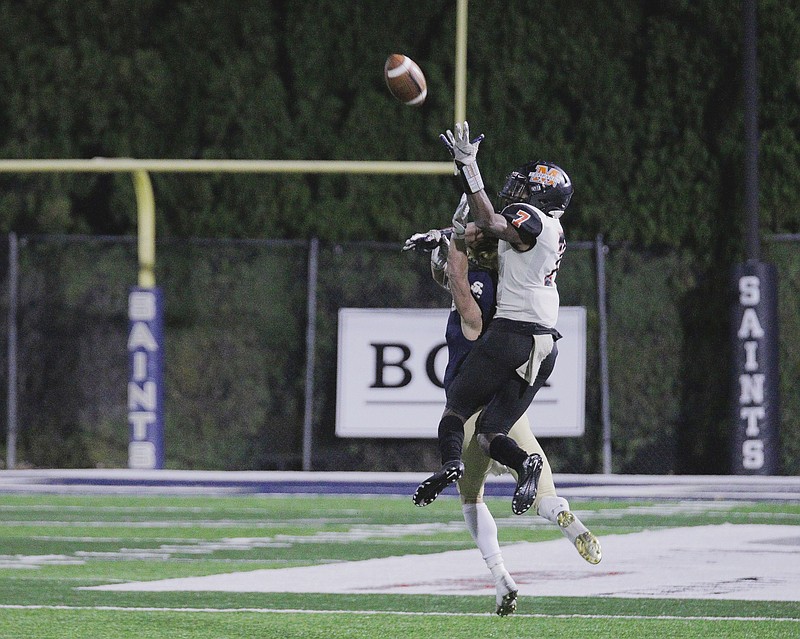 Shiloh Christian Saints sophomore Eli Wisdom (2) breaks up a pass intended for Malvern Leopards senior Dante Reed (7) during a Class 4A quarterfinal game Friday at Champions Stadium in Springdale. - Photo by Brent Soule, Special to NWA Democrat-Gazette