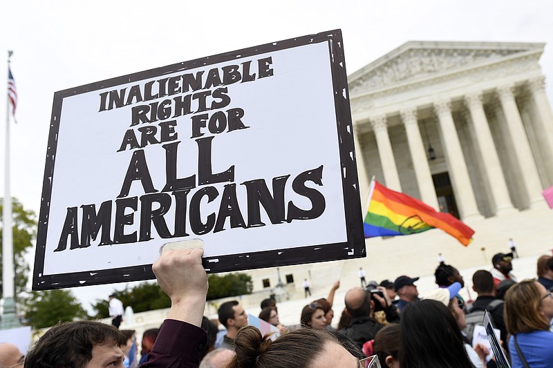 In this Oct. 8, 2019, file photo, protesters gather outside the Supreme Court in Washington where the Supreme Court is hearing arguments in the first case of LGBT rights since the retirement of Supreme Court Justice Anthony Kennedy.  As vice president in 2012, Joe Biden endeared himself to many LGBTQ Americans by endorsing same-sex marriage even before his boss, President Barack Obama. Now, as president-elect, Biden is making sweeping promises to LGBTQ activists, proposing to carry out virtually every major proposal on their wish lists. - AP Photo/Susan Walsh