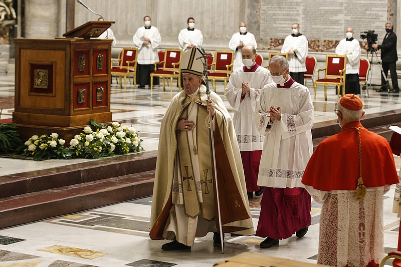 Pope Francis leaves at the end of a consistory ceremony where 13 bishops were elevated to a cardinal's rank in St. Peter’s Basilica at the Vatican, Saturday. - Fabio Frustaci/POOL via AP