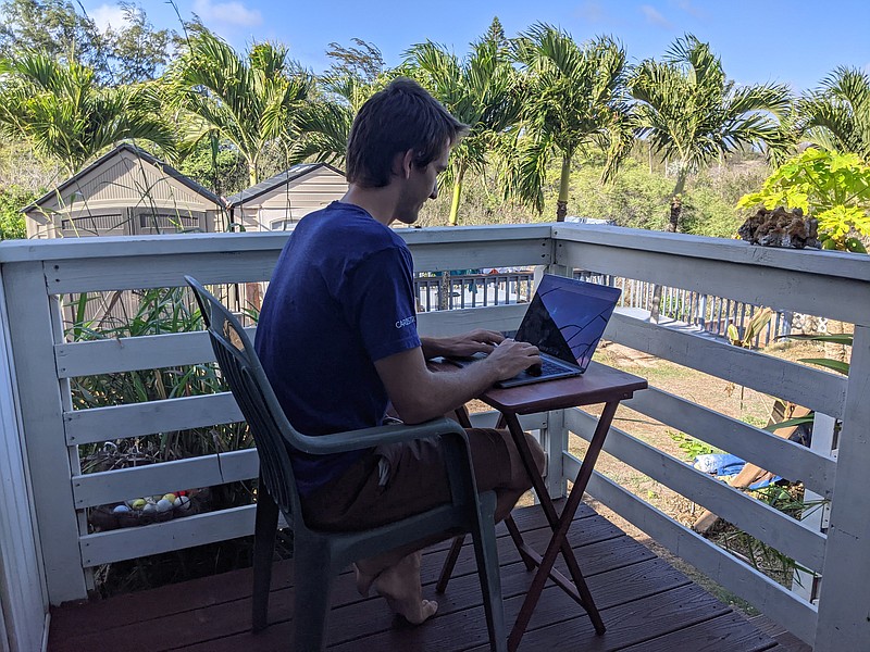 In this photo provided by Marley C. Alford, Raymond Berger, a New York City software engineer, works remotely on Nov. 22 in Kahului, Hawaii. A group of Hawaii leaders is trying to attract people like Berger to work remotely from Hawaii during the pandemic. - Marley C. Alford via AP