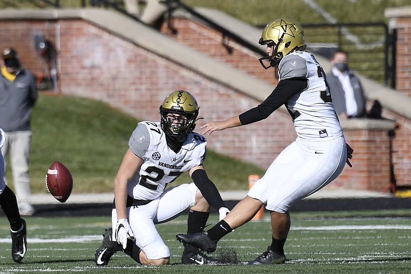Vanderbilt's Sarah Fuller, right, kicks off as Ryan McCord (27) holds to start the second half of Saturday's game against Missouri in Columbia, Mo. With the kick, Fuller became the first female to play in a Southeastern Conference football game. - Photo by L.G. Patterson of The Associated Press