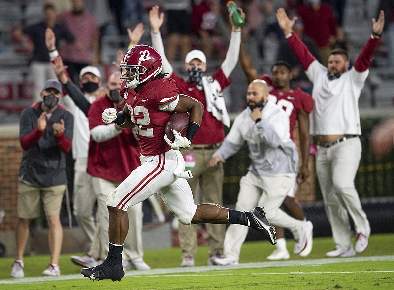 Alabama running back Najee Harris (22) scores a touchdown on a long run against Auburn during an NCAA college football game Saturday, Nov. 28, 2020, in Tuscaloosa, Ala. (Mickey Welsh/The Montgomery Advertiser via AP)
