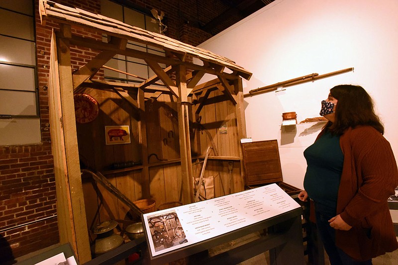 Jennifer Sweet, operations manager at the Rogers Historical Museum, shows Tuesday Nov. 24 2020 a barn that is part of an area agriculture exhibit at the museum. Staff built the barn during the weeks the museum was closed because of virus issues. Go to nwaonline.com/201129Daily/ to see more photos.
(NWA Democrat-Gazette/Flip Putthoff)