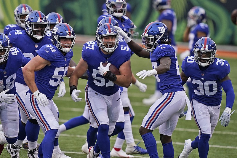New York Giants defensive end Niko Lalos (57) celebrates an interception with teammates during the second half of an NFL football game against the Cincinnati Bengals, Sunday, Nov. 29, 2020, in Cincinnati. (AP Photo/Bryan Woolston)