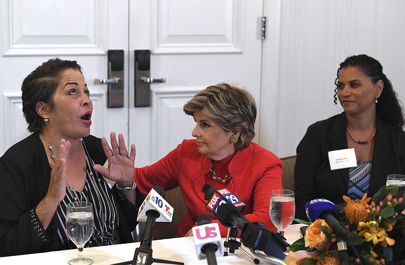 FILE - In this Sept. 23, 2018 file photo, attorney, Gloria Allred, center, along with her clients, Chelan Lasha, left, and Lise-Lotte Lublin, right, both of whom have accused Bill Cosby of sexual assault, talk to the media during a press conference at the Le Meridien Hotel in Philadelphia, Pa. Cosby has spent more than two years in prison since he was convicted of sexual assault in the first celebrity trial of the #MeToo era. Now the Pennsylvania Supreme Court is set to hear his appeal of the conviction on Tuesday, Dec. 1, 2020. The arguments will focus on the trial judge's decision to let five other accusers testify for the prosecution.  (Jose F. Moreno/The Philadelphia Inquirer via AP, File)