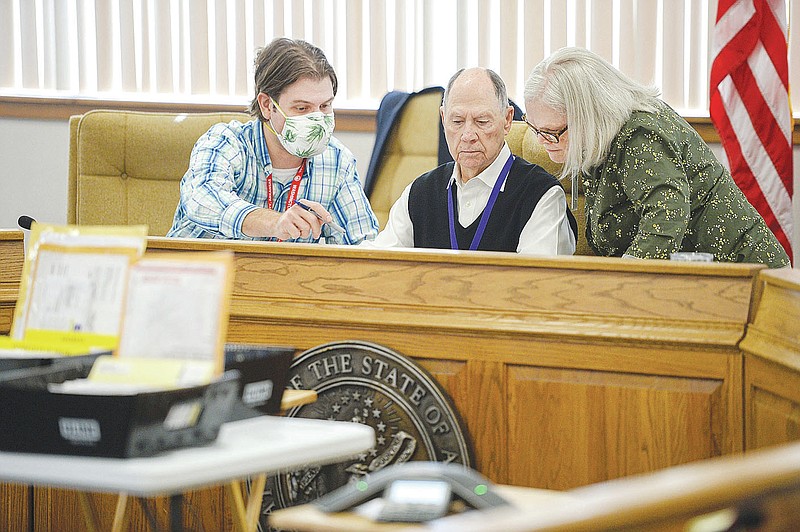 Max Deitchler (from left) and Bill Ackerman, both members of the Washington County Election Commission, work Thursday Nov. 5, 2020, with Renee Oelschlaeger commission chairman as they discuss absentee ballots that arrived with problematic signatures during a meeting of the commission in the Washington County Courthouse in Fayetteville. 
(NWA Democrat-Gazette/Andy Shupe)