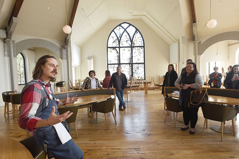 NWA Democrat-Gazette/FLIP PUTTHOFF 
Matthew Cooper, executive chef, talks Saturday Nov. 9 2019 about the architecture of his restaurant, The Preacher's Son in downtown Bentonville. The building was once a church.