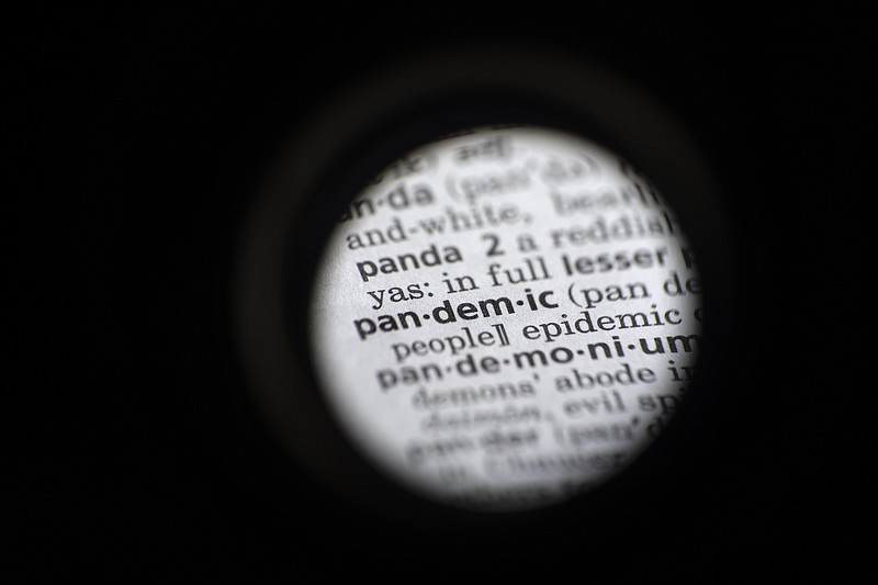 In this Saturday, Nov. 21, photo taken through a camera lens the word "pandemic" is seen in a dictionary in Washington. Dictionary.com declared “pandemic” its 2020 word of the year. - AP Photo/Jenny Kane