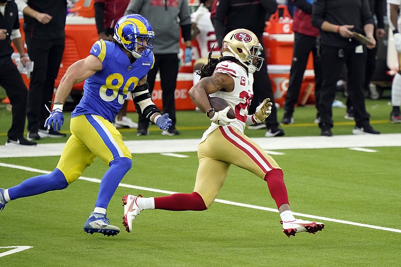 San Francisco 49ers cornerback Richard Sherman, right, runs back with an intercepted pass next to Los Angeles Rams tight end Tyler Higbee (89) during the first half of Sunday's game in Inglewood, Calif. - Photo by Alex Gallardo of The Associated Press