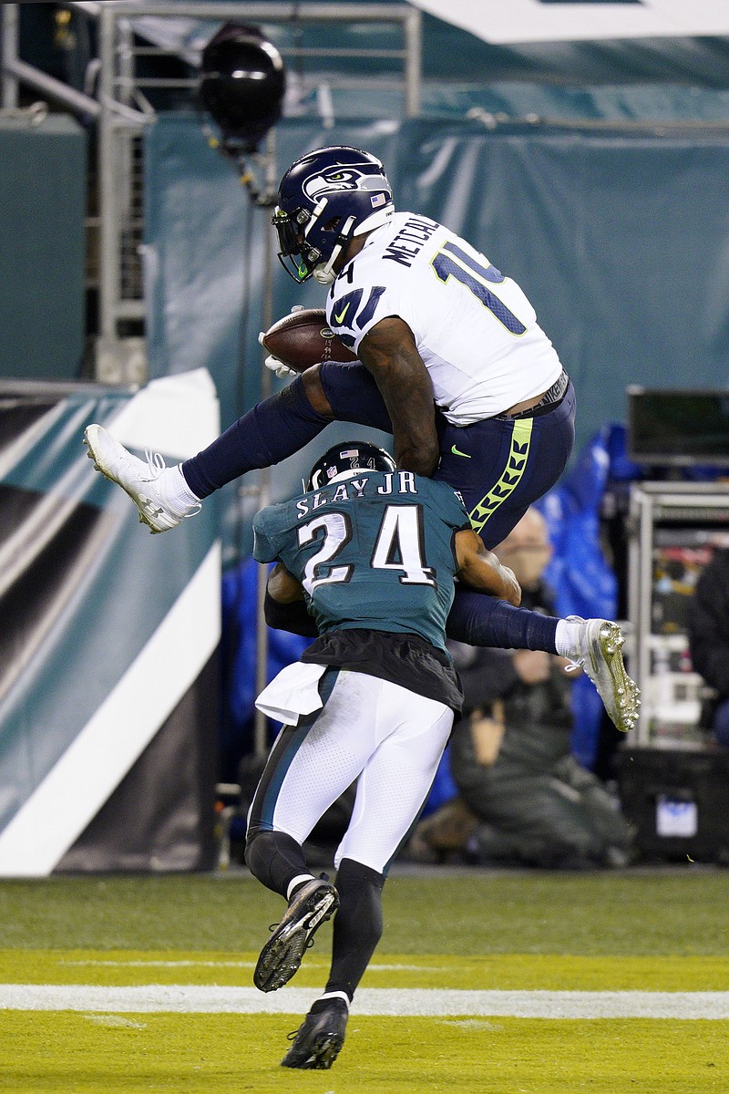 Seattle Seahawks' DK Metcalf (14) tries to hurdle Philadelphia Eagles' Darius Slay (24) during the first half of Monday's game in Philadelphia. - Photo by Chris Szagola of The Associated Press