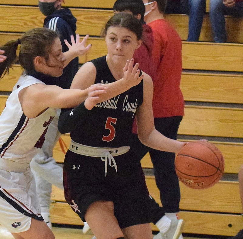 RICK PECK/SPECIAL TO MCDONALD COUNTY PRESS McDonald County's Sydney Killion drives past Joplin's Isabella Yust during the Lady Eagles 34-25 win on Nov. 30 in the Freeman Sports Medicine CJ Classic at Carl Junction High School.