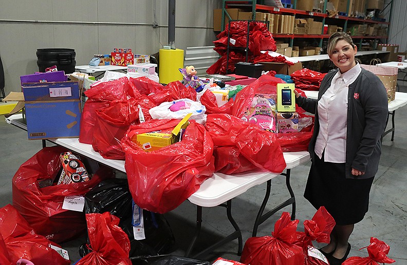 The Salvation Army Captain Stephanie Hargis stands with some of the Angel Tree gifts on Thursday. -  Photo by Richard Rasmussen of The Sentinel-Record