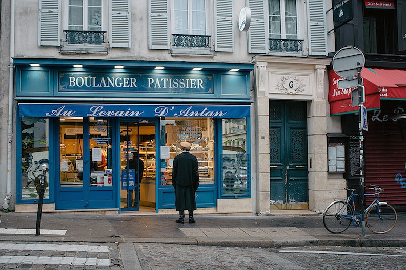 Coronavirus safety rules are posted on the showcase of a bakery in Paris on March 16, 2020. (Dmitry Kostyukov/The New York Times)