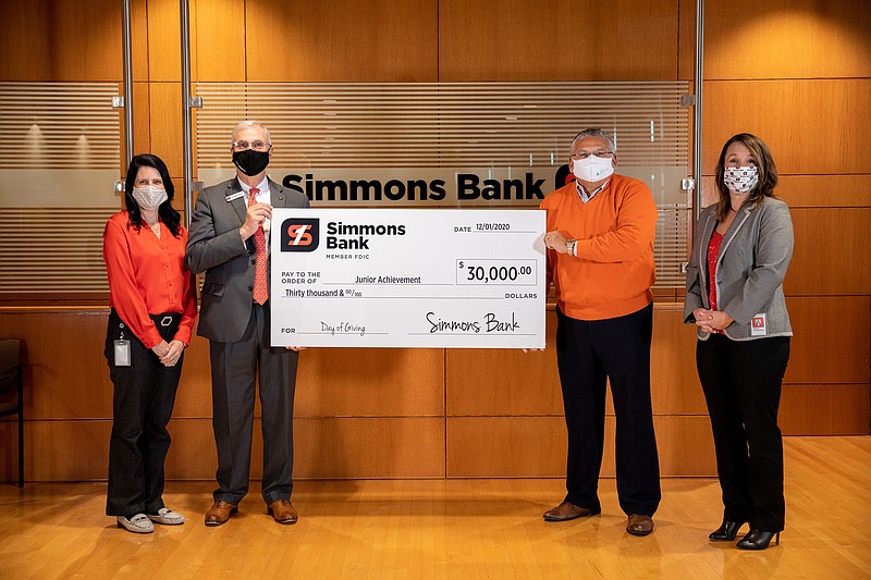 Simmons Bank officials present the third annual Giving Tuesday Donation to Junior Achievement. (Special to The Commercial)