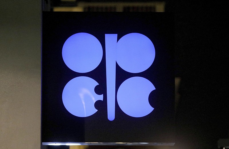 FILE - In this Dec. 19, 2019 file photo, the advertising label of the Organization of the Petroleum Exporting Countries, OPEC, shines at their headquarters in Vienna, Austria.  Leaders of the OPEC cartel are meeting virtually to decide how much oil their countries should produce as the coronavirus stifles demand for fuel. They’re expected to extend production cuts into the new year in an effort to boost prices. (AP Photo/Ronald Zak, File)