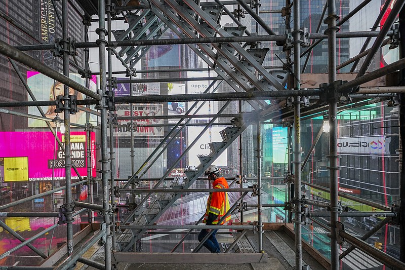 A construction worker walks down a staircase in the scaffolding of TSX Broadway under construction, Thursday, Oct. 29, 2020, in New York's, Times Square. The 46-story mixed-use property will house 75,000 square feet of retail space, a 4,000-square-foot performance venue including an outdoor stage, an outdoor food and beverage terrace and a luxury hotel. U.S. construction spending rose 0.3% in September, the fourth straight monthly gain after a coronavirus-caused spring swoon. (AP Photo/Mary Altaffer) story.lead_photo.caption