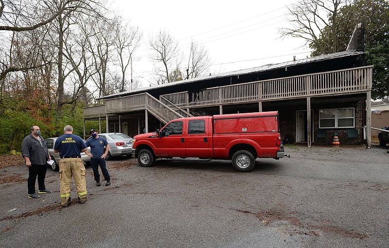 Personnel from the Fayetteville Fire Marshal's office collect information Saturday, Nov. 21, 2020, after a fire at the Myers Apartments on South Gregg Avenue in Fayetteville.
(NWA Democrat-Gazette/Andy Shupe)