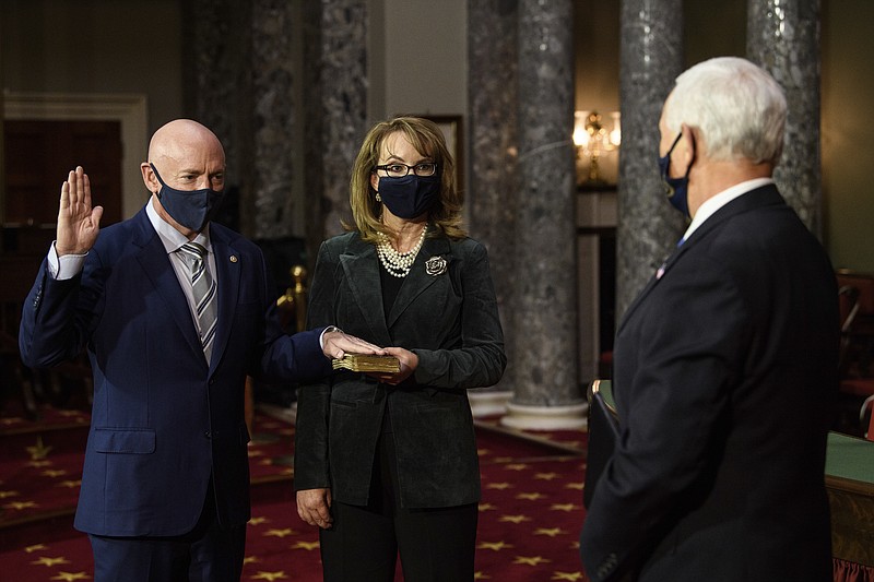 Sen. Mark Kelly, D-Ariz., with his wife former Rep. Gabby Giffords, D-Ariz., participates in a re-enactment of his swearing-in Wednesday, Dec. 2, 2020, by Vice President Mike Pence in the Old Senate Chamber on Capitol Hill in Washington. (Nicholas Kamm/Pool via AP)