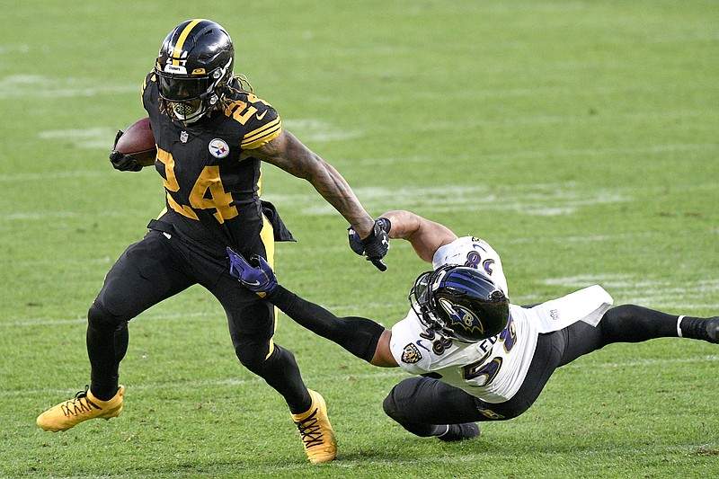 Pittsburgh Steelers running back Benny Snell (24) runs away from Baltimore Ravens outside linebacker L.J. Fort (58) during the first half of an NFL football game, Wednesday, Dec. 2, 2020, in Pittsburgh. (AP Photo/Don Wright)