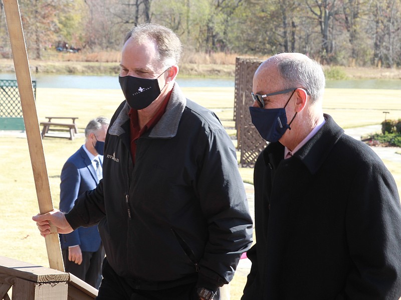 George Dunklin Jr., left, owner and manager of Five Oaks Duck Lodge, located a few miles south of Stuttgart, talks with UA System President Donald Bobbitt following a signing ceremony formalizing a partnership with the UA System Division of Agriculture, allowing UA Monticello to use the lodge property for a graduate certificate program on wetlands and waterfowl habitat management. (Pine Bluff Commercial/Dale Ellis)