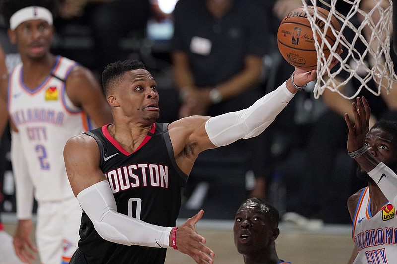 FILE - In this Wednesday, Sept. 2, 2020 file photo, Houston Rockets' Russell Westbrook (0) goes up for a shot as Oklahoma City Thunder's Nerlens Noel, right, defends during the second half of an NBA first-round playoff basketball game in Lake Buena Vista, Fla. The Houston Rockets have traded Russell Westbrook to the Washington Wizards for John Wall and a future lottery-protected. first-round pick. 
Both teams announced the trade Wednesday night, Dec. 2, 2020. (AP Photo/Mark J. Terrill, File)