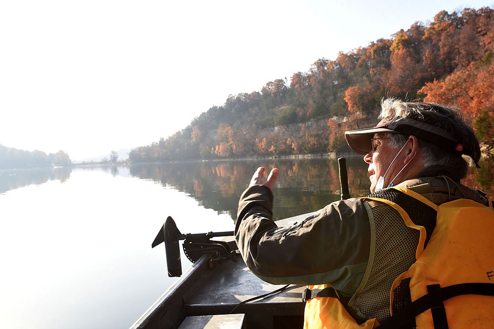 A calm, sun-splashed morning Nov. 6 2020 proved ideal for birding by boat. Joe Neal looks for birds near Rocky Branch park on Beaver Lake.
(NWA Democrat-Gazette/Flip Putthoff)