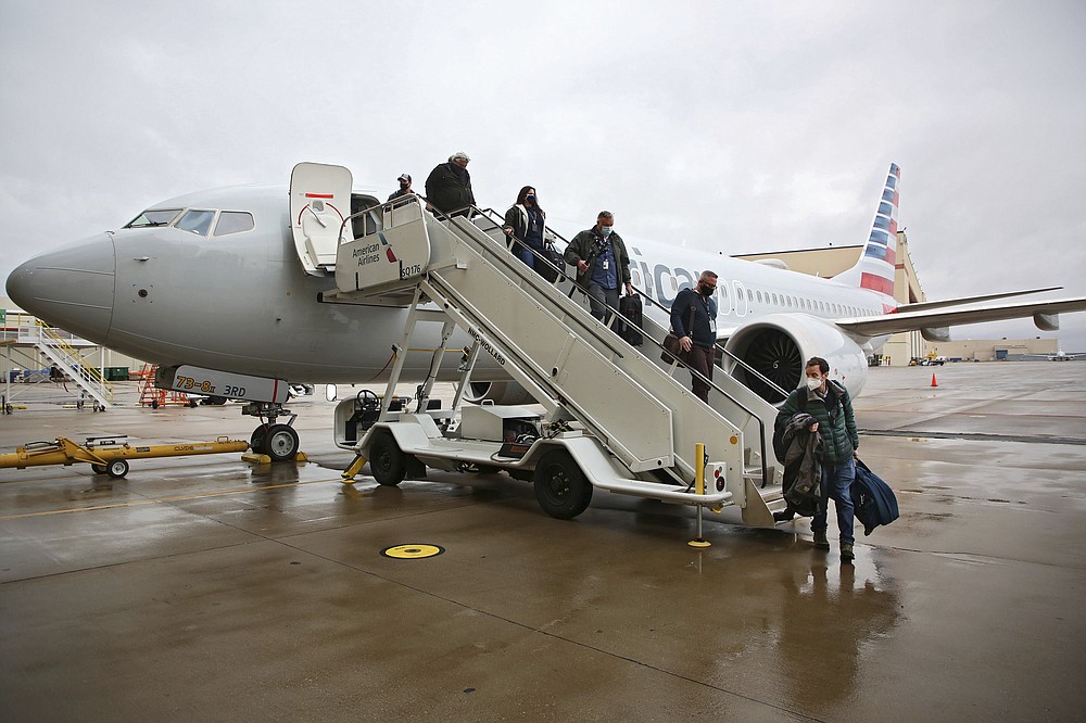 Journalists and American Airlines employees board a Boeing 737 Max at American Airlines Tulsa maintenance facility on Wednesday, December 2, 2020 in Tulsa, Okla. Earlier, the plane had flown a group of journalists and American Airlines employees from Dallas to American Airlines Tulsa maintenance facility. (Mike Simons / Tulsa World via AP)