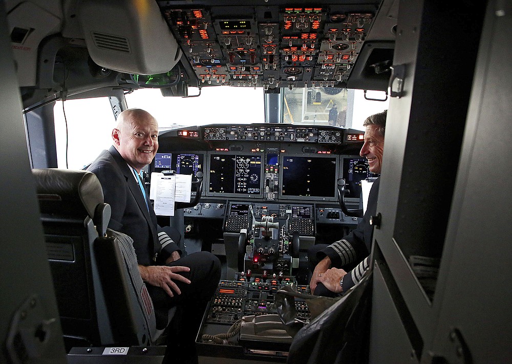Pilots Peter Gamble, left, and John Konstanzer talk to reporters and crew members after flying a Boeing 737 Max from Dallas and arriving at American Airlines Tulsa maintenance facility on Wednesday, December 2, 2020 in Tulsa, Okla. Earlier, the plane had flown a group of journalists and American Airlines employees from Dallas to American Airlines Tulsa maintenance facility. (Mike Simons / Tulsa World via AP)