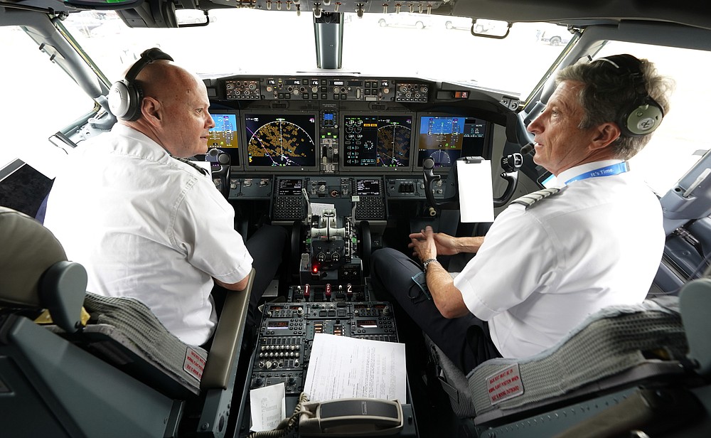 CORRECTING THE FIRST NAME OF PETE, NOT PET - American Airlines pilot Captain Pete Gamble, left and foreman John Konstanzer speaks in the cockpit of a Boeing 737 Max jet before taking off from Dallas Fort Worth Airport in Grapevine, Texas, Wednesday, December 2, 2020. American Airlines took its long-ground Boeing 737 Max jets out of storage, updated key flight control software and flew the aircraft in preparation for the first pay-per-flight flights later this month. (AP Photo / LM Otero)