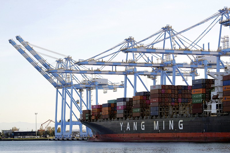 FILE - In this Nov. 4, 2019, file photo, cargo cranes are used to take containers off of a Yang Ming Marine Transport Corporation boat at the Port of Tacoma in Tacoma, Wash. The U.S. trade deficit rose in August to the highest level in 14 years. The Commerce Department reported Tuesday that the gap between the goods and services the United States sells and what it buys abroad climbed 5.9% in August to $67.1 billion.(AP Photo/Ted S. Warren, File)