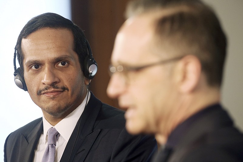 Qatar's Foreign Minister Sheikh Mohammed bin Abdulrahman Al Thani, left, and German Foreign Minister Heiko Maas, right, address the media after a meeting at the foreign office in Berlin, Germany, Wednesday, March 4, 2020.  (Wolfgang Kumm/dpa via AP)