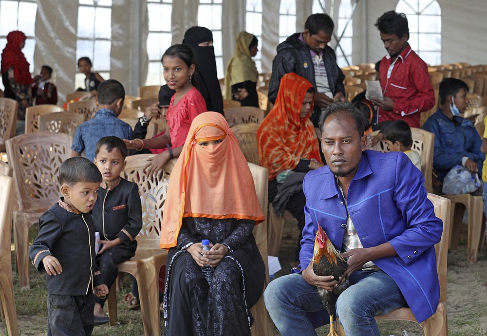Rohingya refugees wait to be transported on a naval vessel to Bhashan Char, or floating island, in the Bay of Bengal, from Chittagong, Bangladesh, Friday, Dec. 4, 2020. Authorities in Bangladesh on Friday started sending a first group of nearly more than 1,500 Rohingya refugees to an isolated island despite calls by human rights groups for a halt to the process. (AP Photo).