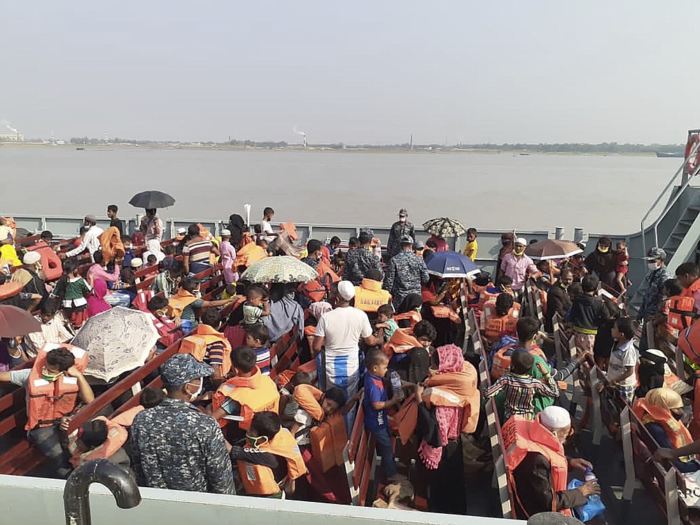 Rohingya refugees board a ship as they are ferried to Bhashan Char, or floating island, in the Bay of Bengal, from Chittagong, Bangladesh, Friday, Dec. 4, 2020. Authorities in Bangladesh on Friday started sending a first group of nearly more than 1,500 Rohingya refugees to an isolated island despite calls by human rights groups for a halt to the process. (AP Photo/Saleh Noman)