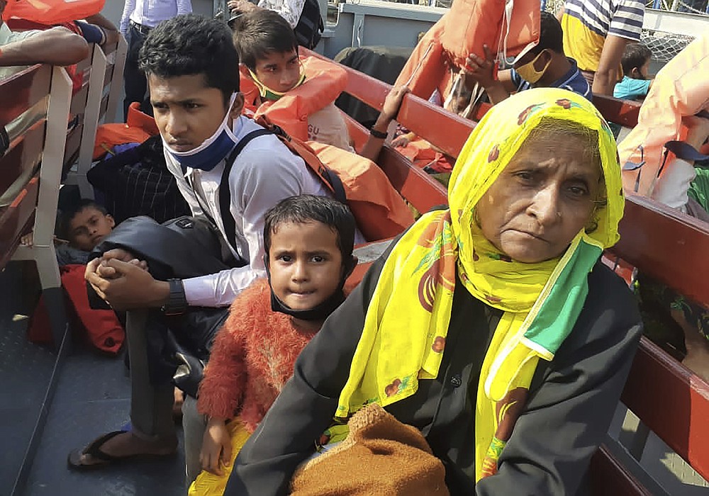 Rohingya refugees board a ship as they are ferried to Bhashan Char, or floating island, in the Bay of Bengal, from Chittagong, Bangladesh, Friday, Dec. 4, 2020. Authorities in Bangladesh on Friday started sending a first group of nearly more than 1,500 Rohingya refugees to an isolated island despite calls by human rights groups for a halt to the process. (AP Photo/Saleh Noman)