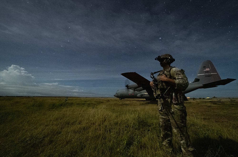 U.S. Army Spc. Kevin Martin, junior sniper, assigned to the 1-186th Infantry Battalion, Task Force Guardian, Combined Joint Task Force - Horn of Africa, provides security for a 75th Expeditionary Airlift Squadron (EAS) C-130J Super Hercules during unloading operations at an unidentified location in Somalia Sunday, June 28, 2020. No country has been involved in Somalia's future as much as the United States but now the Trump administration is thinking of withdrawing the several hundred U.S. military troops from the nation at what some experts call the worst possible time. (Tech. Sgt. Christopher Ruano/Combined Joint Task Force - Horn of Africa via AP)