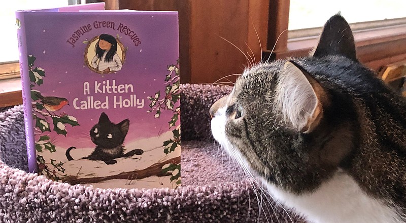 Opie the Cat sniffs "Jasmine Green Rescues: A Kitten Called Holly" by Helen Peters, illustrated by Ellie Snowdon (Walker Books, Sept. 1), ages 7 to 9, 160 pages, $14.99 hardback. $6.99 paperback, 99-cent eBook. (Arkansas Democrat-Gazette/Celia Storey)