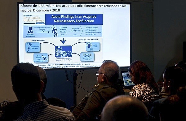 FILE - In this March 14, 2019, file photo, Cuban officials make a presentation on a series of mysterious illnesses suffered by U.S. and Canadian diplomats in Havana, reiterating that no evidence supports allegations that the symptoms resulted from high-tech attacks, during a news conference in Havana, Cuba. A report by the National Academy of Sciences has found that “directed” microwave radiation is the likely cause of illnesses among American diplomats in Cuba and China. The study commissioned by the State Department and released Saturday, Dec. 5, 2020, is the latest attempt to find a cause for mysterious illnesses that emerged in late 2016 among U.S. personnel in Havana. (AP Photo/Ramon Espinosa, File)