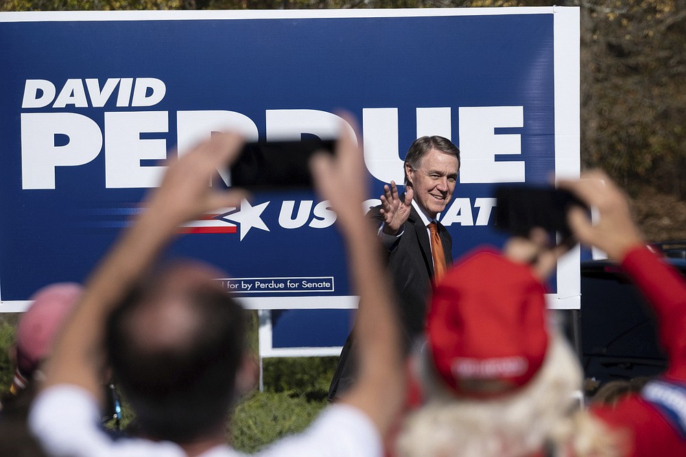 Sen. David Perdue, R-Ga., takes the stage before Vice President Mike Pence during a Defend the Majority Rally, Friday, Nov. 20, 2020 in Canton, Ga. (AP Photo/Ben Gray)