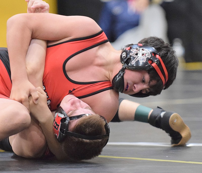 RICK PECK/SPECIAL TO MCDONALD COUNTY PRESS McDonald County's Blaine Ortiz pins Eli Stein in the semifinals of the Neosho Wrestling tournament on his way to the finals where he claimed a 10-4 decision over Talan Braswell of Springdale Har-Ber for the title.