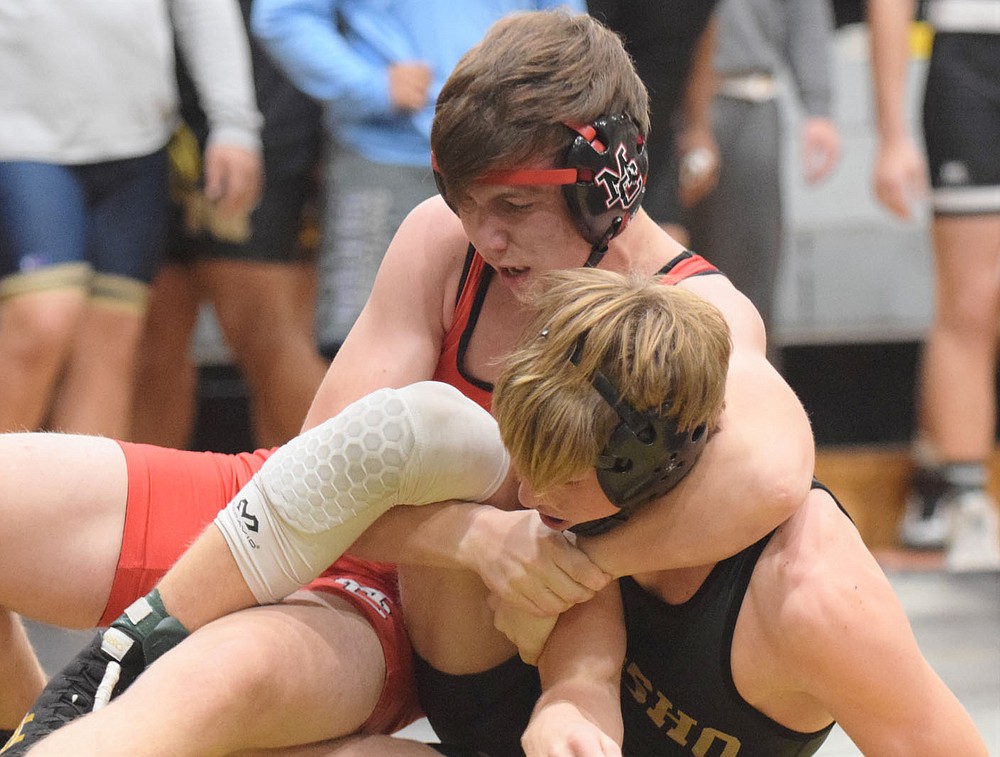 RICK PECK/SPECIAL TO MCDONALD COUNTY PRESS McDonald County's Colter Vick battles Collyn Kivett of Neosho in the semifinals of the Neosho Holiday Tournament. Kivett won the match by a pin, but Vick came back to win third place with a pin over Joshua Puente of Bentonville West.