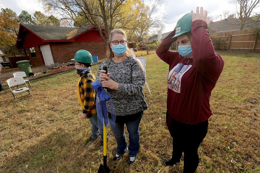 Zoe Griffis (from right), 17, stands with her mother Angela Sockrider and her brother Lyric Cote, 10, as they prepare to break ground Monday, November 9, 2020, during a Habitat for Humanity of Benton County ground breaking event for a new home for Sockrider at 808 N. 31st Street in Rogers. Check out nwaonline.com/201126Daily/ and nwadg.com/photos for a photo gallery.(NWA Democrat-Gazette/David Gottschalk)