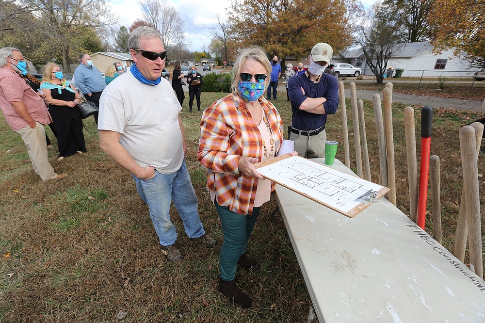 Diana Holmes (right) reviews the house plans with Philip Fink, construction manager, Monday, November 9, 2020, during a Habitat for Humanity of Benton County ground breaking event for a new home for her daughter Angela Sockrider at 808 N. 31st Street in Rogers. Check out nwaonline.com/201126Daily/ and nwadg.com/photos for a photo gallery.(NWA Democrat-Gazette/David Gottschalk)