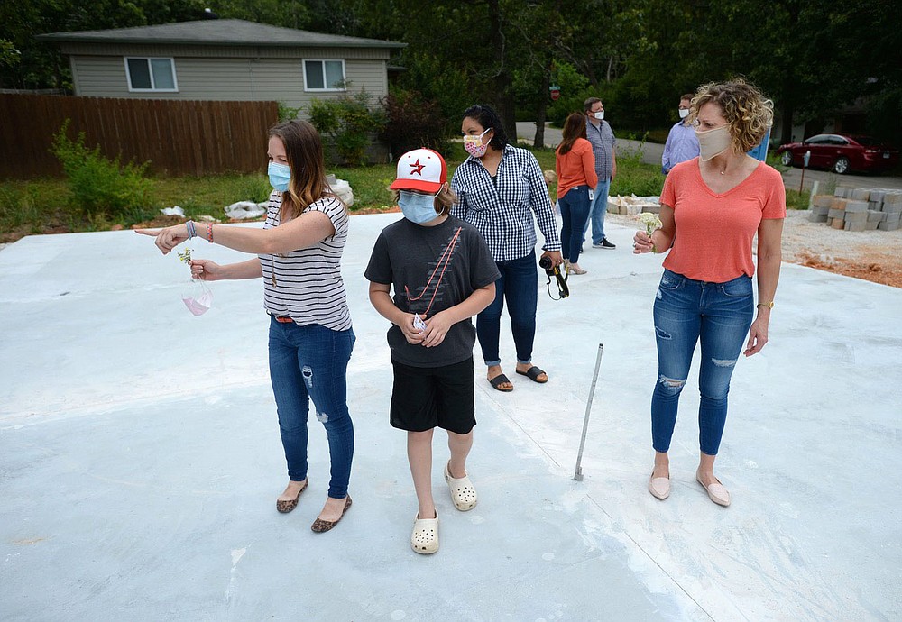 Homeowner Erica Kelso (from left) points out the planned layout of her master bedroom Friday, June 26, 2020, for her son, Louie, 10; daughter, Sophie, 7, (not pictured); and friends Carolina Vargas and Betina Henschell after a ceremony for the house's construction on Oak Road in Fayetteville. The house is being constructed by Habitat for Humanity of Washington County as the organization's 2020 Realtor Build house through a partnership with local real estate and industry partners and volunteers. Visit nwaonline.com/200627Daily/ for today's photo gallery.
(NWA Democrat-Gazette/Andy Shupe)
