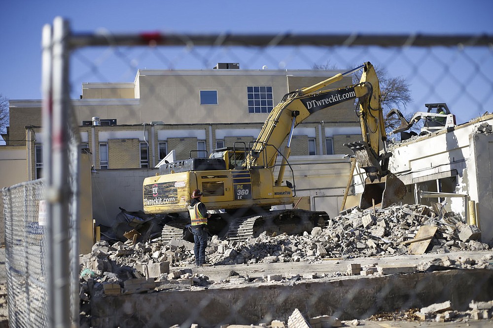 A construction crew demolishes, Monday the building between the courthouse and the County Administration building in Bentonville. Check out nwaonline.com/201208Daily/ for today's photo gallery. (NWA Democrat-Gazette/Charlie Kaijo)