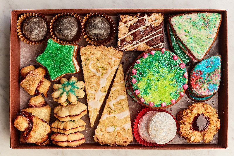 The most festive, tasty and safest way to spread good cheer is gifting an assortment of homemade cookies such as Fudgy Bourbon Balls, Black and White Brownies, Sparkly Gingerbread, Honey-Roasted Peanut Thumbprints, Toasted Almond Snowballs, Cornmeal Lime Shortbread and Vanilla Bean Spritz Cookies. (The New York Times/Johnny Miller)