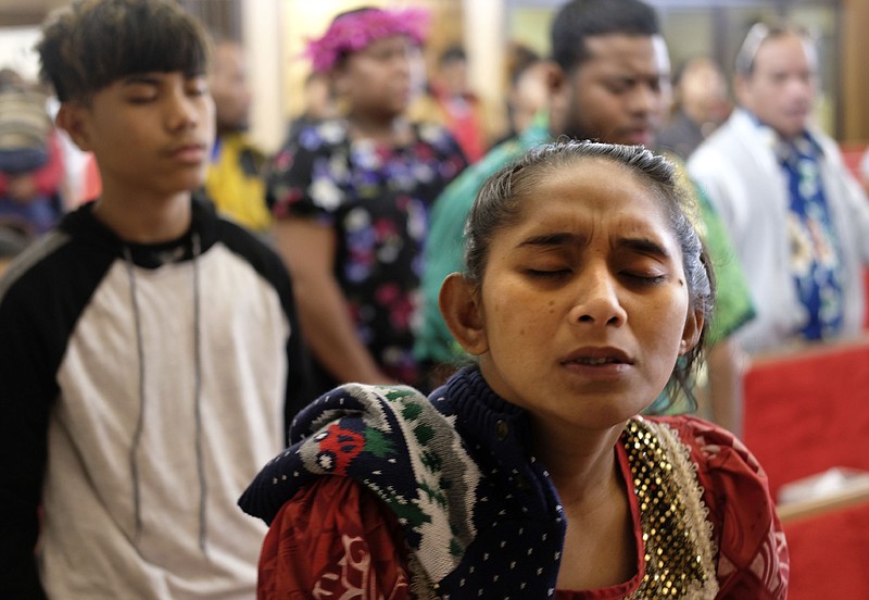 Joann Konou closes her eyes during an evening service at the Noel, Mo., First Marshallese Throne in Jouj church Nov. 22.
(AP Photo/Luis Andres Henao)