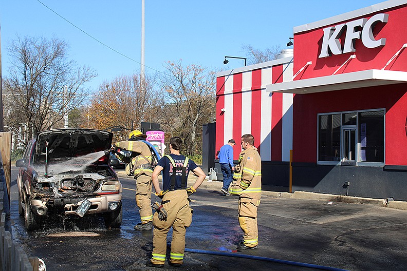 Hot Springs Fire Department personnel responded to a vehicle on fire in the drive-thru at the KFC/Taco Bell, 141 E. Grand Ave. on Wednesday. - Photo by Tanner Newton of The Sentinel-Record