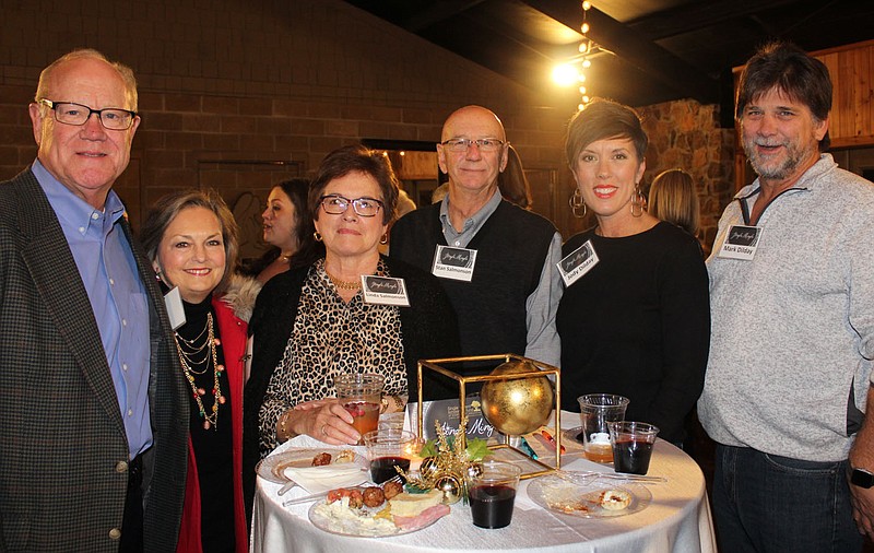 Jim and Cathy Crouch (from left), Linda and Gordon Salmonson and Jody and Mark Dilday visit at Jingle Mingle in 2019.
(File photo/NWA Democrat-Gazette/Carin Schoppmeyer)