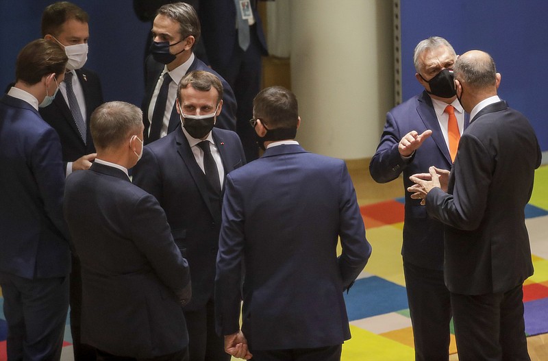 French President Emmanuel Macron, center, speaks with Czech Republic's Prime Minister Andrej Babis, third left, and Poland's Prime Minister Mateusz Morawiecki, center right, during a round table meeting at an EU summit at the European Council building in Brussels, Thursday, Dec. 10, 2020. European Union leaders meet for a year-end summit that will address anything from climate, sanctions against Turkey to budget and virus recovery plans. Brexit will be discussed on the sidelines. (Olivier Hoslet, Pool via AP)