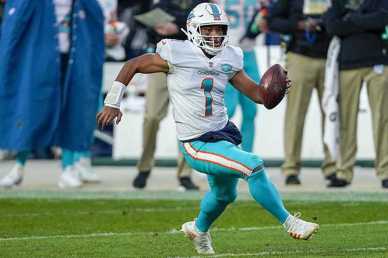 Miami Dolphins quarterback Tua Tagovailoa (1) runs against the Denver Broncos during an NFL football game Sunday, Nov. 22, 2020, in Denver. The focus is on the matchup between Patrick Mahomes and Tua Tagovailoa, even though there’s no debate about which quarterback is better. The Miami Dolphins might have the superior defense, however, which lends intrigue to Sunday’s game against the Kansas City Chiefs.(AP Photo/Jack Dempsey)